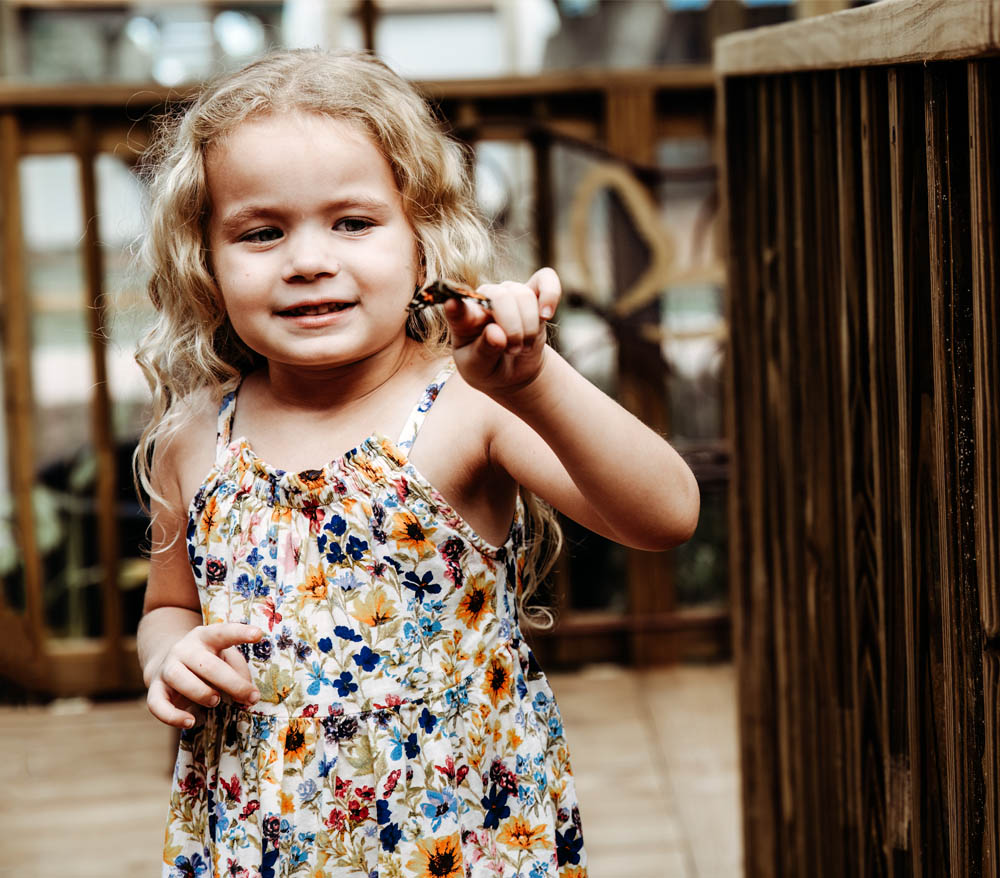 photo of young girl in butterfly garden at boggy creek airboat adventures