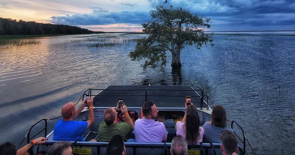 a group of people sitting in front of a body of water