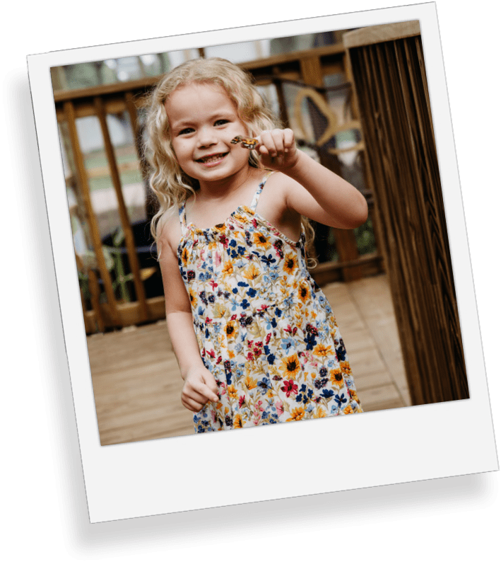 a little girl standing in front of a window