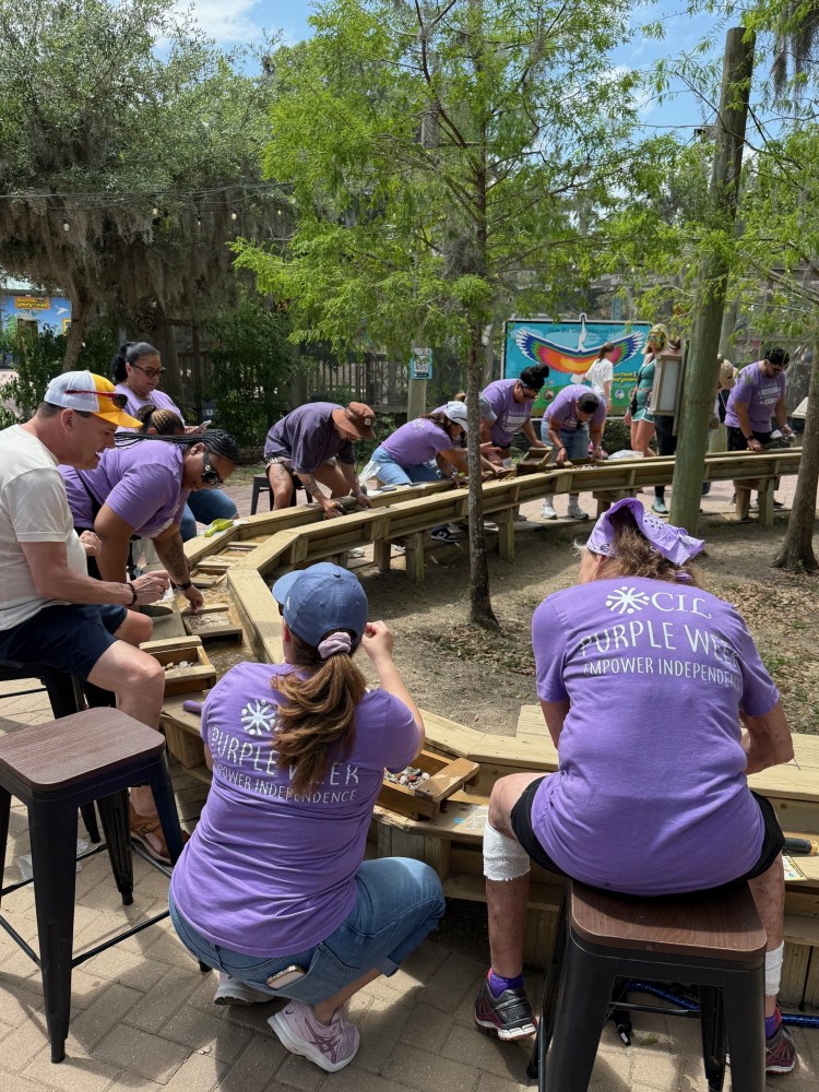a group of people sitting at a picnic table